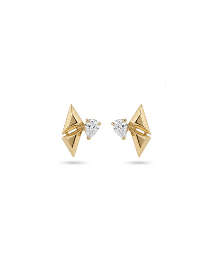 A pair of gold geometric stud earrings with triangular pyramid shapes and a small pear-cut clear gemstone in the center, set against a plain white background.