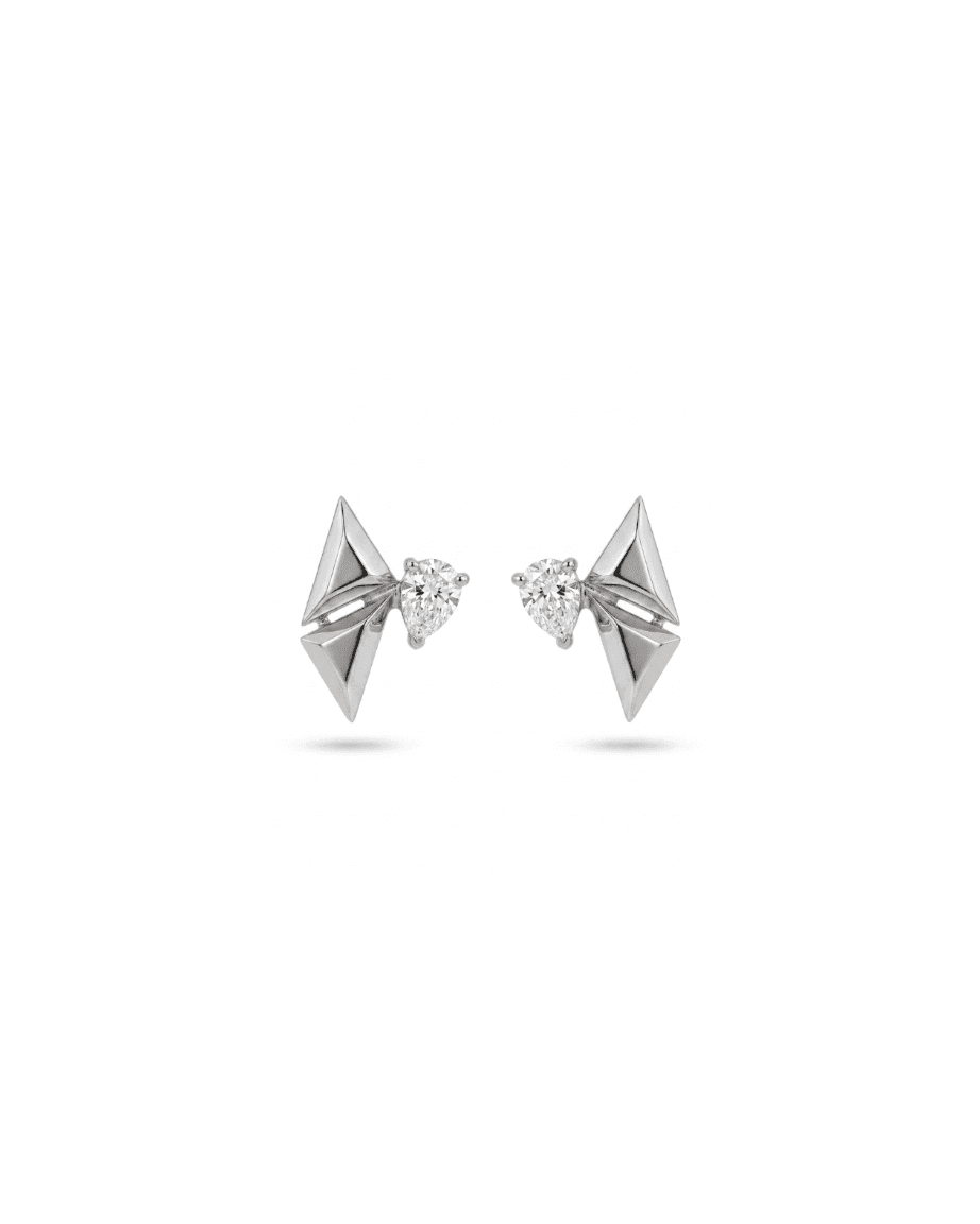 A pair of silver geometric stud earrings with triangular faceted side panels and a central clear heart-shaped gemstone, shown on a white background.