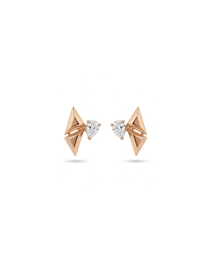A pair of rose gold geometric stud earrings with triangular facets and a small pear-cut clear gemstone in the center, shown on a white background.