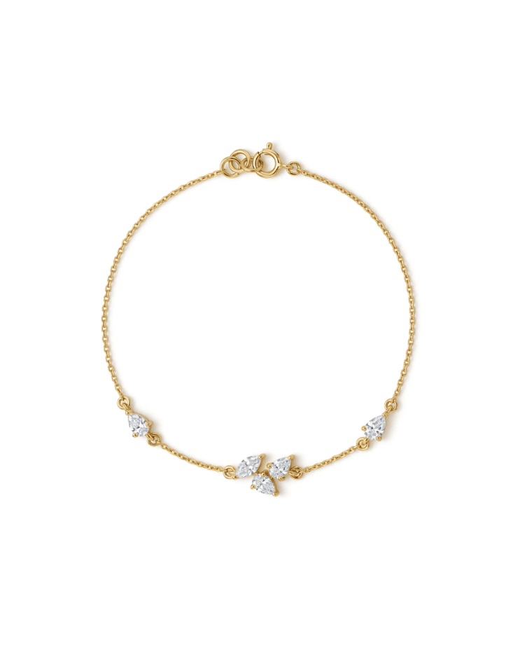 A delicate yellow gold chain bracelet with a lobster clasp and three small clear gemstone accents, displayed on a clean white background.