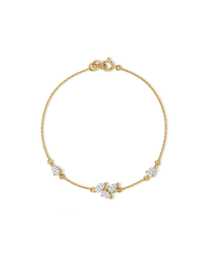 A delicate yellow gold chain bracelet with a lobster clasp and three small clear gemstone accents, displayed on a clean white background.