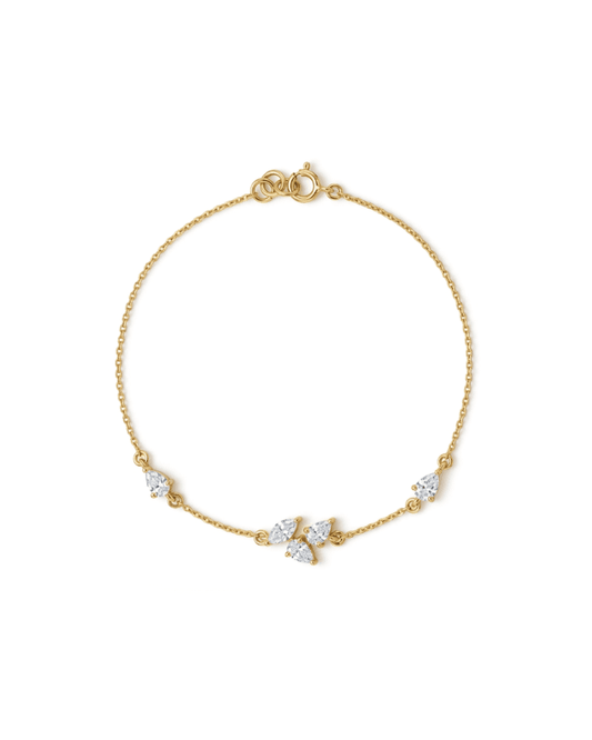 A delicate yellow gold chain bracelet with a lobster clasp and three small clear gemstone accents, displayed on a clean white background.