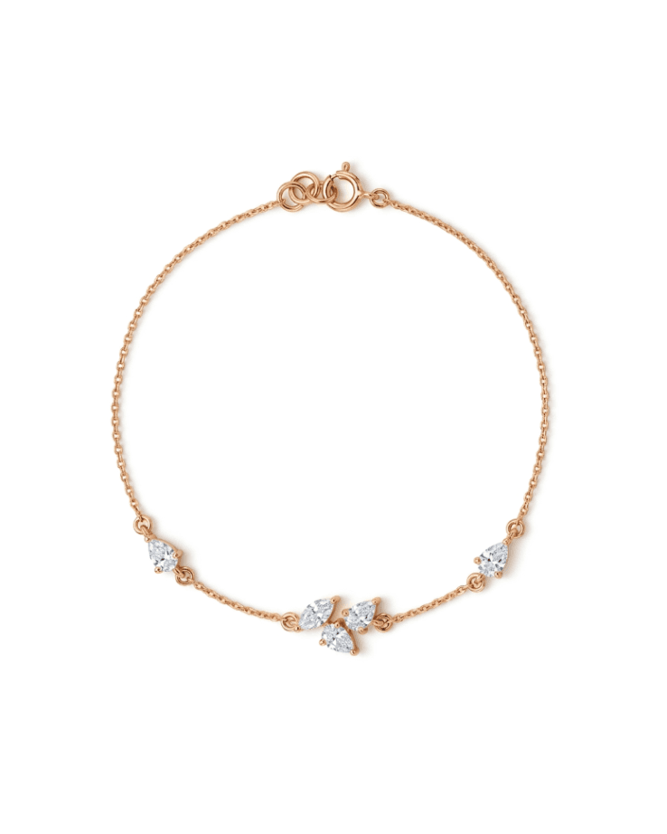 A delicate rose gold chain bracelet with a small cluster of clear marquise-cut and round gemstones at the center, displayed on a clean white background.
